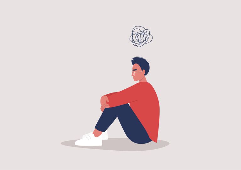 年轻抑郁的男性角色坐在地板上，抱着膝盖，他们的头上有卡通涂鸦，心理健康问题